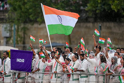 Indian athletes wave the national flags during the opening ceremony